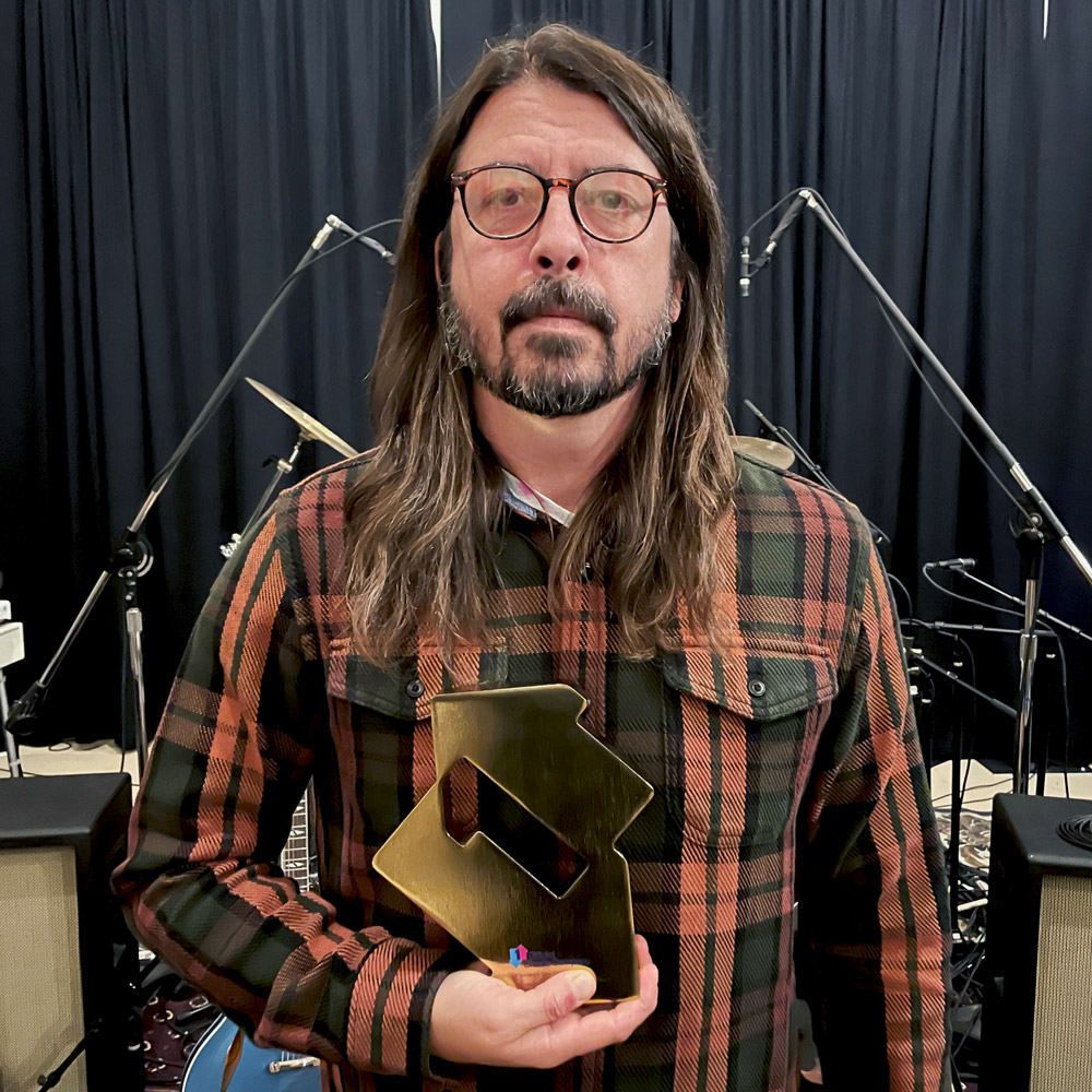 Dave Grohl holding Foo Fighters' Official Charts award