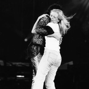 Michael Jackson hugs a fan on stage circa 1985