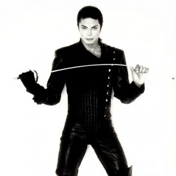 Michael dressed with a fencing black suit