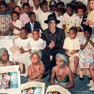Michael Jackson sits with Ivory Coast children during a visit in 1992.
