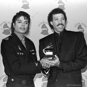 Michael Jackson and Lionel Richie hold their GRAMMY Award for "We Are The World" on February 25, 1986 at the Shrine Auditorium in Los Angeles, California.