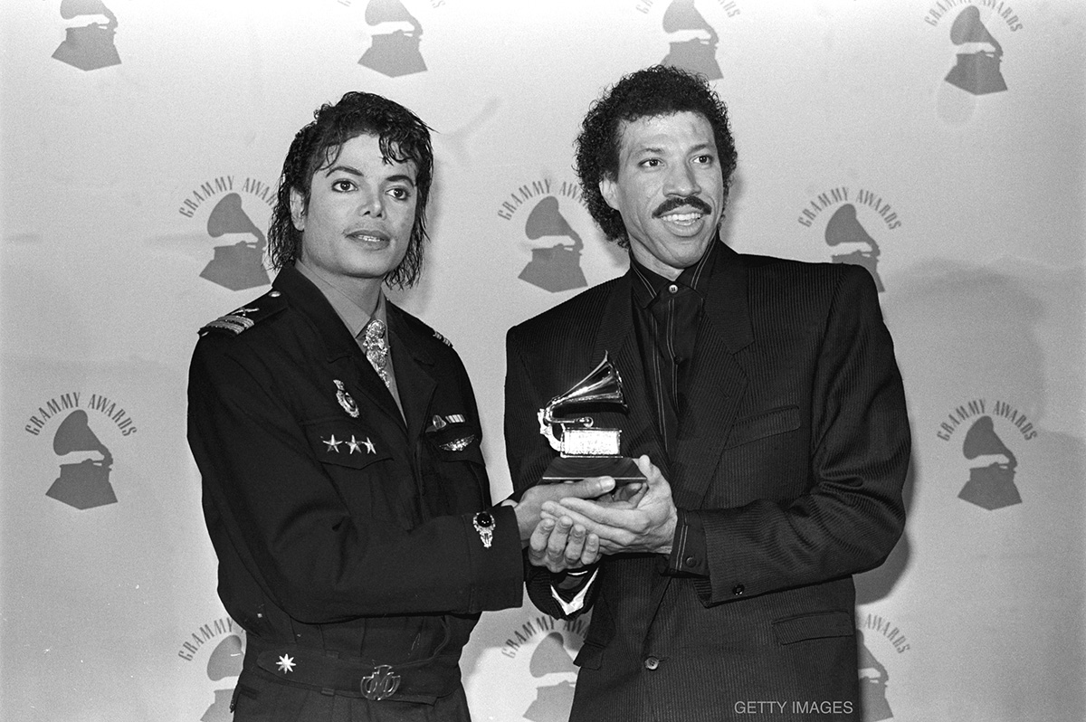 Michael Jackson and Lionel Richie hold their GRAMMY Award for "We Are The World" on February 25, 1986 at the Shrine Auditorium in Los Angeles, California.