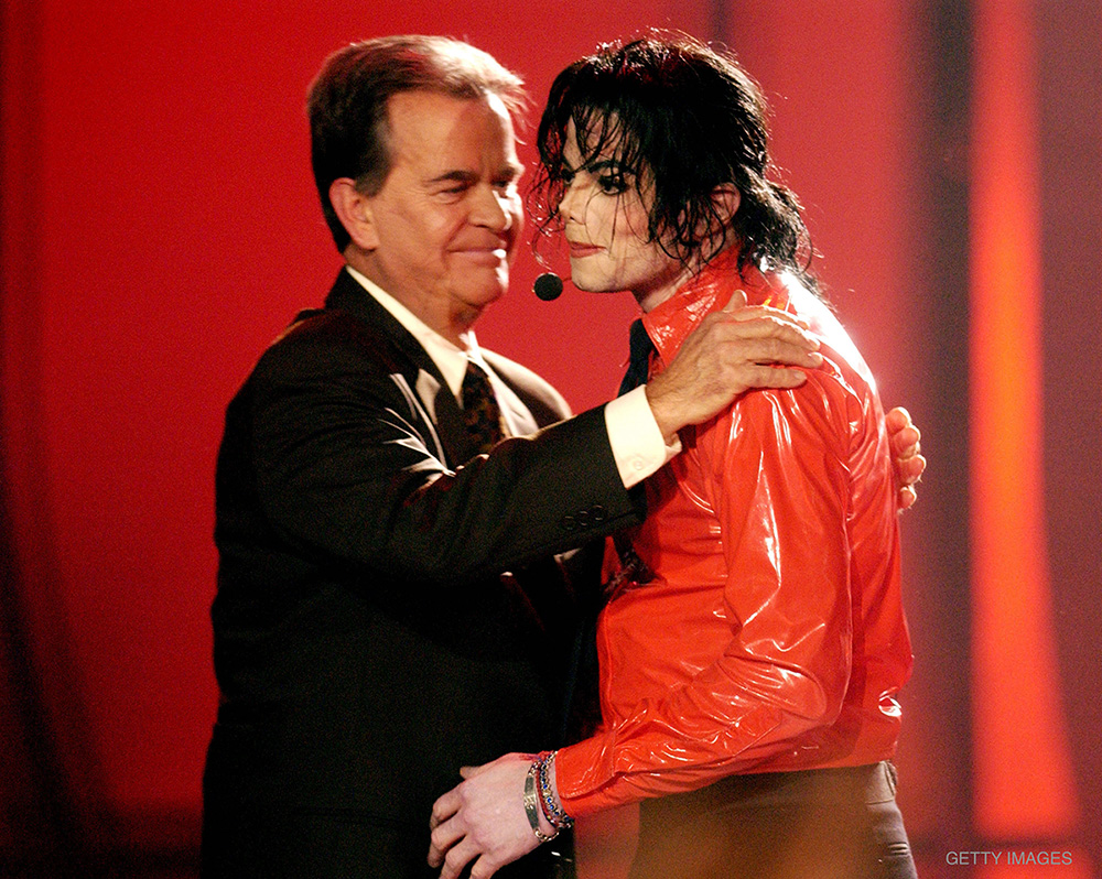Dick Clark hugs Michael Jackson during a performance break at the taping of American Bandstand's 50th Anniversary Celebration on April 20, 2002. The show aired May 3, 2002 ﻿on ABC-TV.