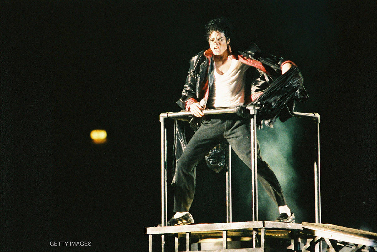 Michael Jackson performs on a stage platform during his Dangerous World Tour in 1992.
